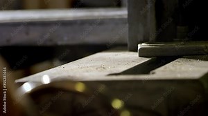 Close up of vise closing as man turns wheel