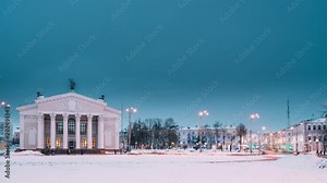 Gomel, Belarus. Time Lapse Time-lapse From Day To Night. Traffic And Light Trails Near Building Of Gomel Regional Drama Theatre On The Lenin Square In Winter Season. Change Of Day To Night
