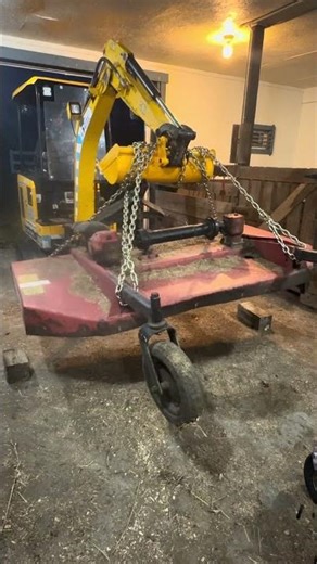 Electric JCB 19C-1e moving a 800lb bush hog mower