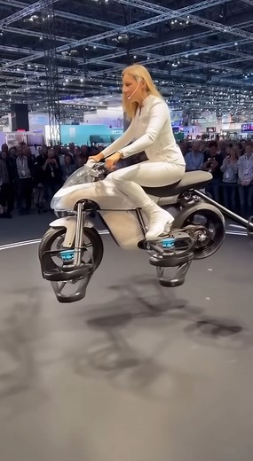 103K views · 569 reactions | A futuristic mini white sportsbike with six powerful rotors takes flight at a tech expo! Watch as a presenter demonstrates its hovering, turning, and smooth lift-off. This flying motorcycle concept could be the future of daily commuting. Would you ride this? ✨ #FlyingBike #TechExpo #FutureTech #Innovation | Pro Inventions | Facebook