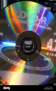 DVD hole around caps lock light diffraction spectrum colours disc audio video Stock Photo - Alamy