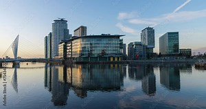Salford Quays time lapse video showing a transaction between day to night and building reflection at the waterfront.