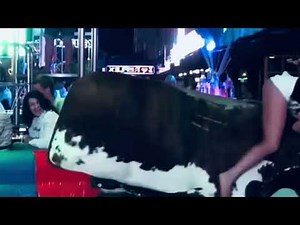 Short skirt girl riding bull