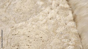 High angle footage of waste water during treatment process. Lockdown shot of dirty water in motion.