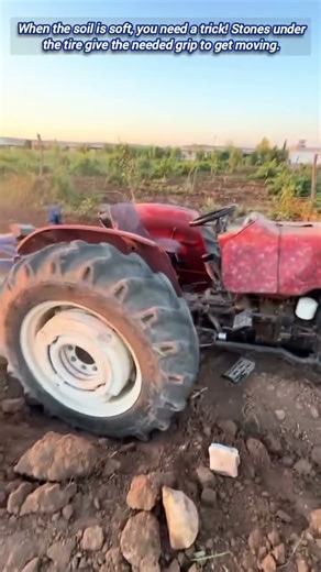 Watch how to free a stuck tractor using basic stones.