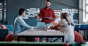 Meeting, collaboration and presentation with a business team talking strategy or planning behind a pool table. Teamwork, coaching and training with a man and woman employee group in a workshop