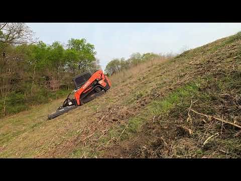 Mowing extremely steep slope with the Kubota SVL65-2