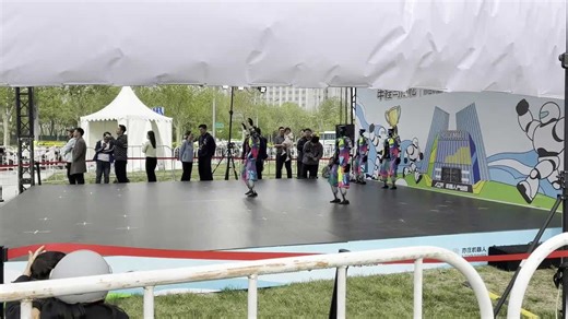 Robots perform impressive dance routine on outdoor stage