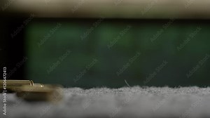 Empty bullet shells fall down raining after firing gun at shooting range, slow motion from close up