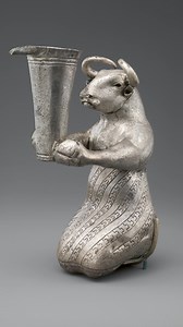 At least 4900 years old, this sculpture is attributed to the Proto-Elamite culture of southwestern Iran. It is made of silver and features a kneeling bull in anthropomorphic posture holding a spouted vessel. It measures 16.3 x 6.3 x 10.8 cm (6 7/16 x 2 1/2 x 4 1/4 in). This artifact is now housed at the Metropolitan Museum of Art in New York, United States. It was acquired in 1966, purchased from K. Rabenou Ltd. through the Joseph Pulitzer Bequest. We make our content for people like you. You ca