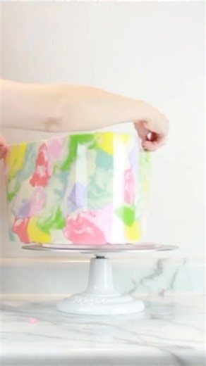 🌈 Fun tip: pause and rotate your piping bag every few shells or spirals when piping rainbows, so every color can be seen! Colors are @Chefmaster , sprinkles & edible luxe dust are @Sweets & Treats | Baking Decor , cake board is @CakeSafe (use code ERIN10 to save!), and 1M tip is @Wilton Cakes . #cakedecorating #rainbowcake #cake #video | Off The Menu