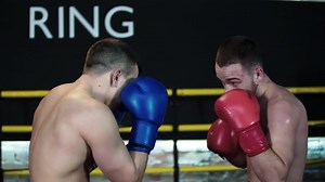 Boxer making hook punch, knockout opponent falls down HD slow motion close-up video. Blows to head on fight ring