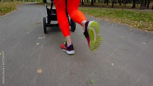 young woman running with a stroller doing sports