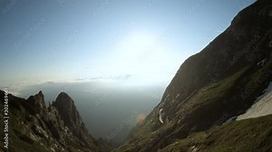 Stunning aerial footage of one paraglider flying over a spectacular mountain view.