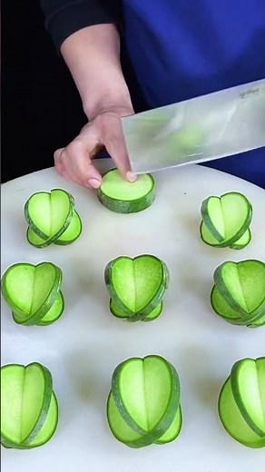 the process of cutting a cucumber using a knife to create aesthetic cuts