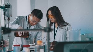 Team of mixed race scientists mixing chemicals using test tubes, microscope and laboratory equipment conducting medical experiments for vaccine development.