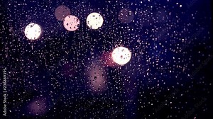 Night city lights in the window in the rain