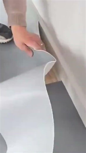 cutting the grey floor sticker precisely using a professional manual sharp metal knife