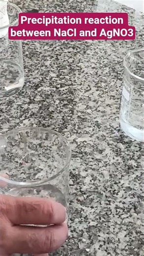 Formation of AgCl as a result of precipitation reaction between NaCl and AgNO3.