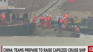 Crews cut into hull of capsized Chinese cruise ship