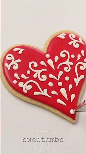 Decorating a Valentine’s Day cookie with royal icing