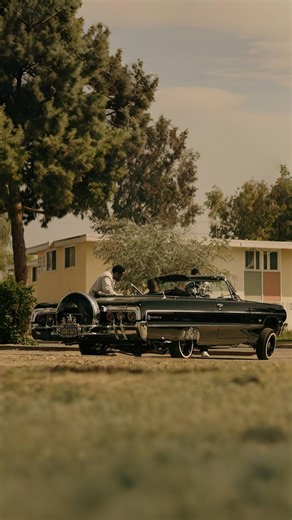 In FX’s crime drama Snowfall, a sleek black 1964 Chevrolet Impala lowrider glides through South Central, its wire wheels and hydraulic bounce embodying the pulse of the streets. More than a ride, this Impala is a symbol of power and cool, stealing the spotlight every time it rolls by. #Snowfall #64Impala #WestCoastStyle #Lowrider #Lowridertv | Lowrider