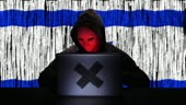 Hacker hacking typing code on his laptop with Israel flag and binary...