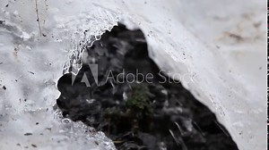water flowing through the ice in a frozen waterfall