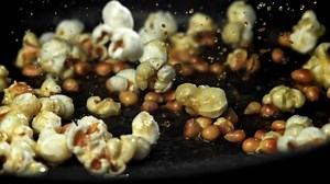 Popcorn explodes in the pan. Filmed on a high-speed camera at 1000 fps. High quality FullHD footage