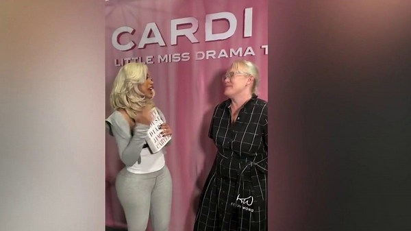 Amy Carter presents Cardi B with book