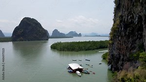 Drone footage of boats docking on a floating bar in Thailand