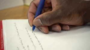 close up african american writing in prison black inmate in jail education 4k classroom