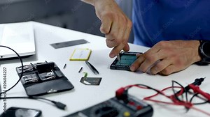 phone repair service - technician repairing smartphone in office