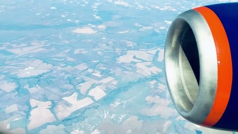 clip-4004903091-airplane-window-view-jet-engine-flying-above