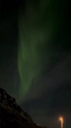 Northern Lights Glow Green and Purple over the Mountains of Iceland