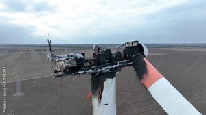 Close-up of a burnt out wind turbine. Wind energy farm turbine destroyed, damaged by fire after a lightning strike. Windmill, energy production