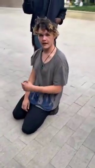 White liberal man bows before Black men and kisses their boots to apologize for slavery.Liberalism is a mental illness.