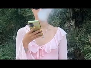 girl in short pink dress smoking and giving interview about smoking