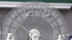 Demonstration of an electrostatic generator producing electric discharge during a physics lesson. Teacher shows students the principles of static electricity and sparks.