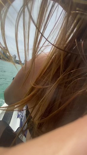 Woman Riding Jet Ski in Vibrant Coastal Cityscape