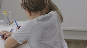 Download Brother helps his younger sister to make her homework for free