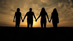 Silhouette of group of people. People holding hand together symbol of unity and helping hand in business. Teamwork unity freedom people. Team of people holding hands together support success victory