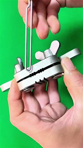 Elastic arms tense—miniature slingshot poised, precision engineered for playful launch