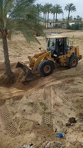 Yellow CAT Backhoe Loader in Action at Construction Site