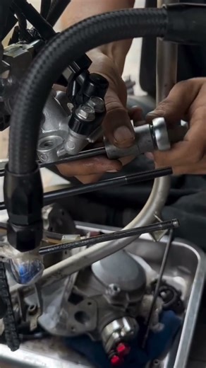 The process of installing long bolts to lock the motorcycle valve cylinder block