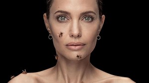 Angelina Jolie poses covered with real bees to raise awareness for bee conservation efforts