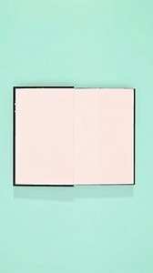 clip-3556216397-black-hardcover-book-appear-open-on-cyan