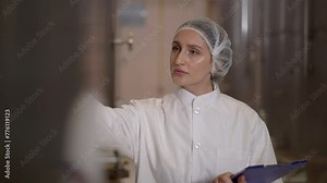 quality control officer examines inside the food and beverage manufacturing factory.