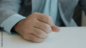 Close-up of male hand hitting table and pushing coffee cup then leaving feeling angry while businessman is expressing negative emotions in office