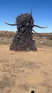 A mysterious 'demonic monolith' has appeared in the California desert, adorned with screaming faces, twisted bodies, serpents and a giant eye carved into its center. Standing more than nine feet tall, the black statue was spotted by several visitors in Joshua Tree National Park over the past few days. Witnesses claim it groans every few minutes, glows at night, and is covered in hundreds of sculpted human corpses. | UFO GOD